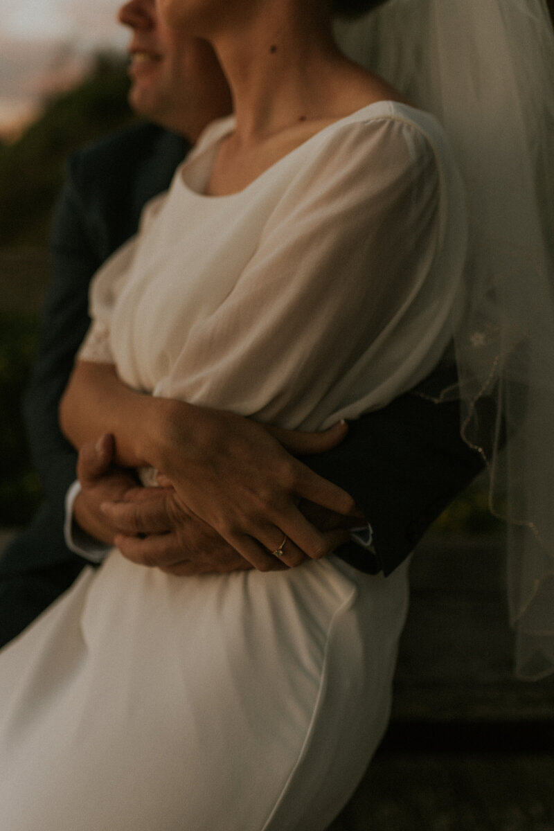 A heartfelt wedding portrait take in Urunga, with a close up of the bride and groom cuddled together holding hands