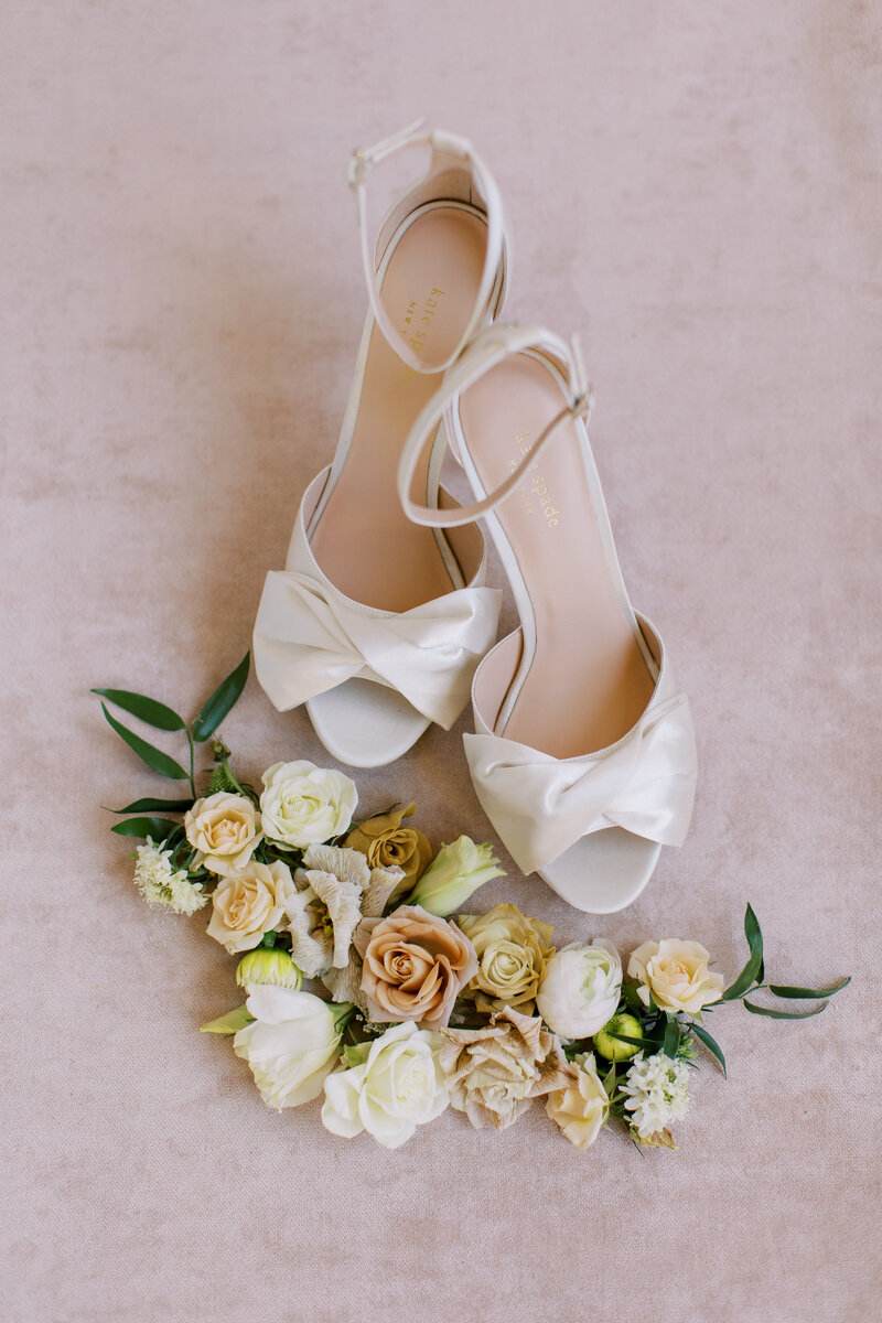 14-radiant-love-events-flatlay-pink-backdrop-delicate-open-toe-bridal-shoes-beautiful-flower-display-around-romantic-elegant-timeless