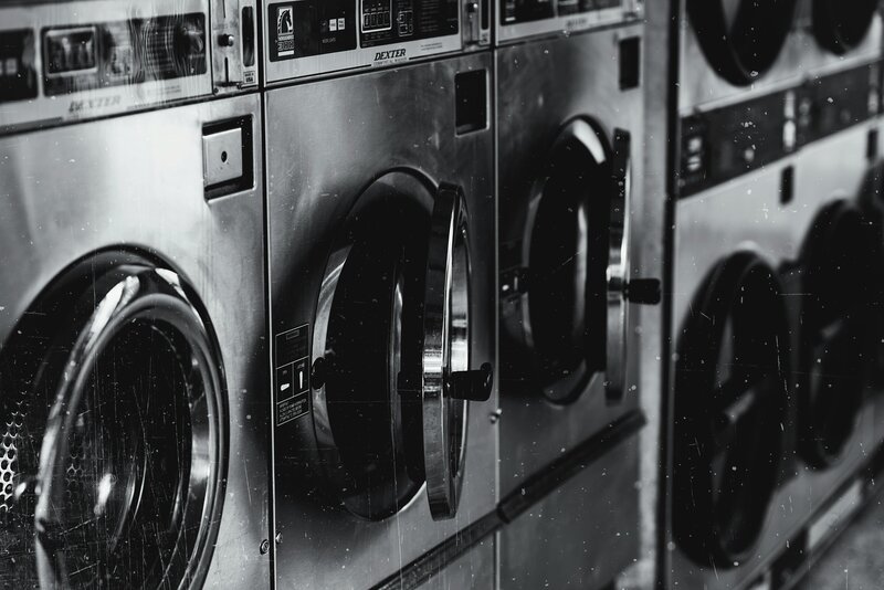 row of washing machines in laundry mat
