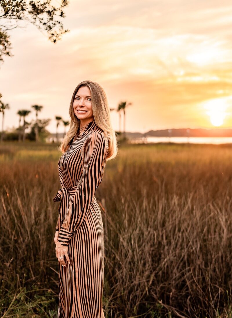 Headshots for a local wellness influencer near a marsh in Mt Pleasant in beautiful golden light