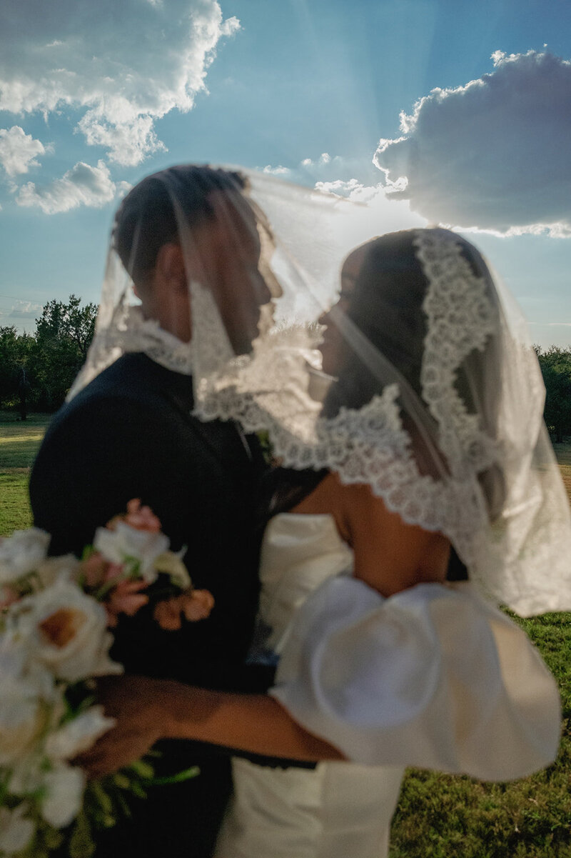 Just married at The Arlo—bride and groom embracing in golden light outside the modern Austin wedding venue.