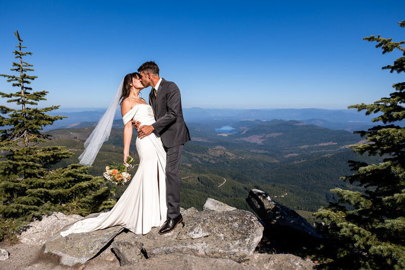 Bride and Groom kissing on top of Mount Spokane