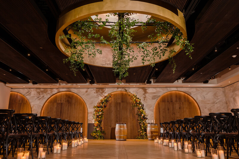 Moody Ceremony space with candles and greenery at Chicago Winery