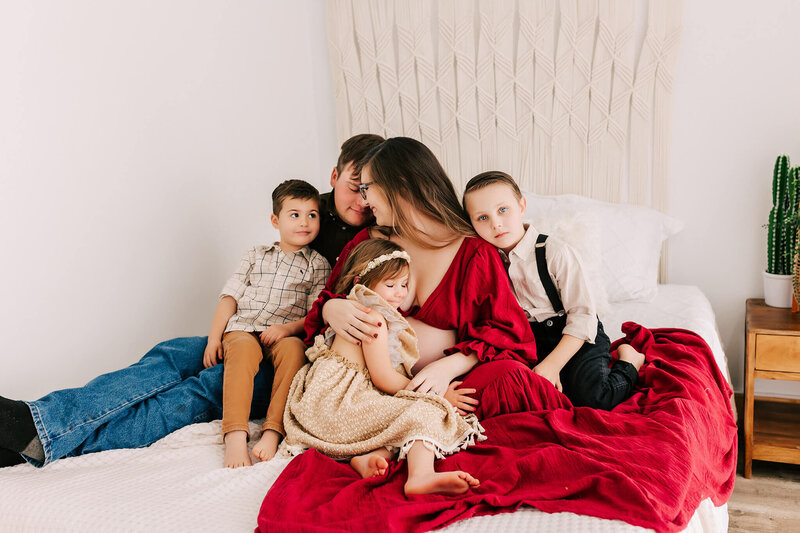 family photo cuddling in bed