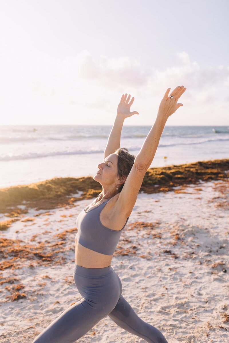 Woman doing yoga on the beach, St. Pete Rejuvenate Aches and Pains IV Hydration Therapy