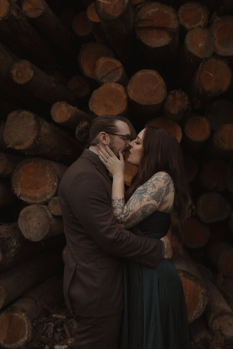 bride and groom kissing in the woods