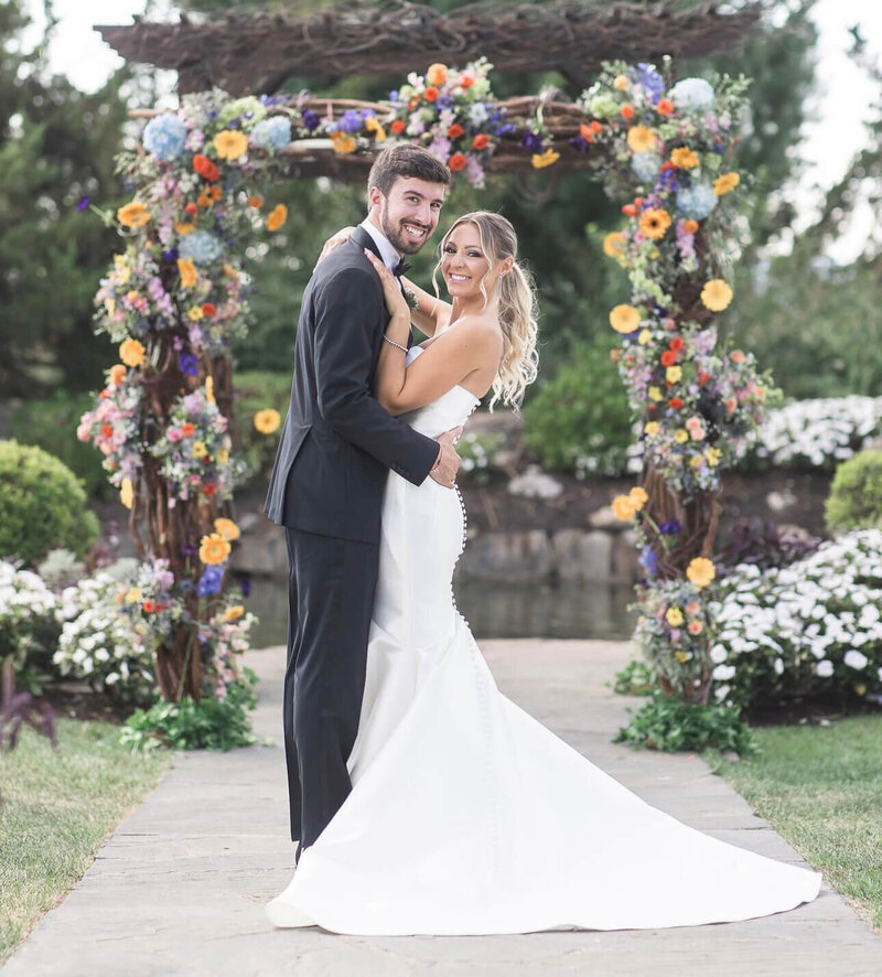 Crystal Springs Wedding in front of their floral arch