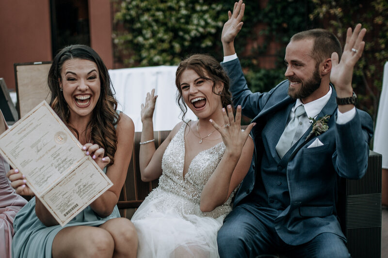 signing the marriage license with their best friend who was the officiant