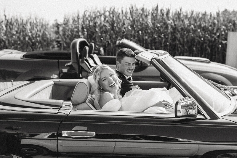 Newlyweds driving away after saying I do in Kitchener, Ontario.