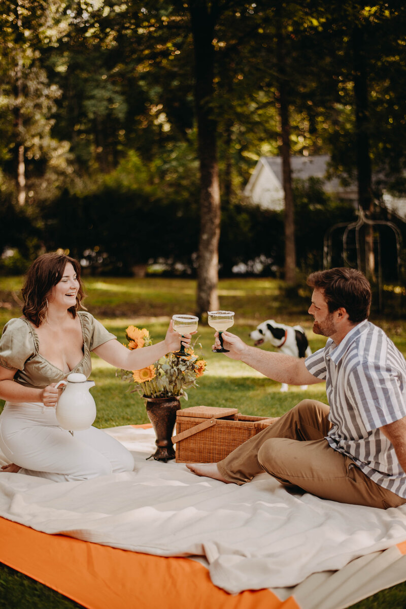 weddings by kattie jackson engagement session couple in the backyard with their dogs 