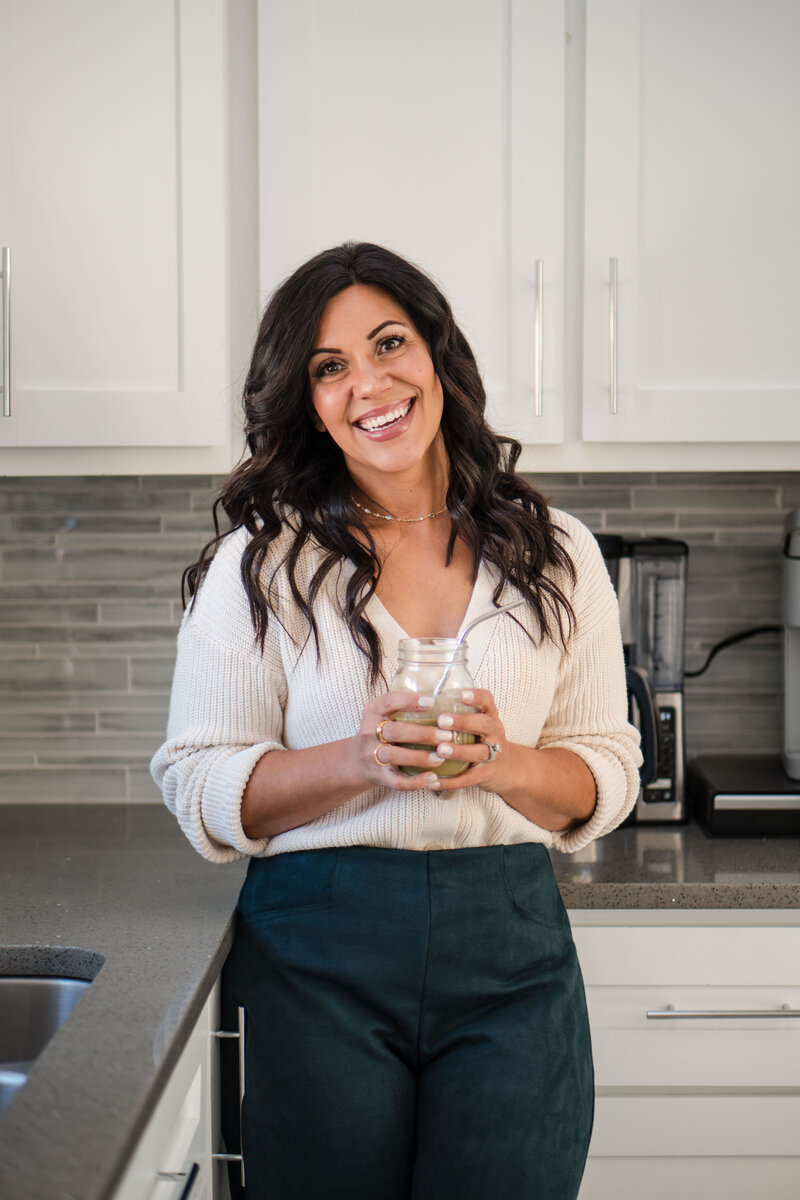 Christian woman holds blue yeti podcast microphone that she has used to build a million dollar business online