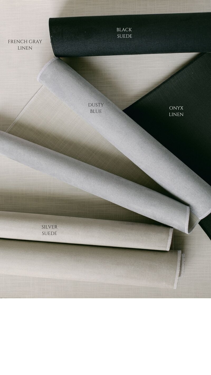 Gray linen styling mat with modern wedding invitations and minimal florals
