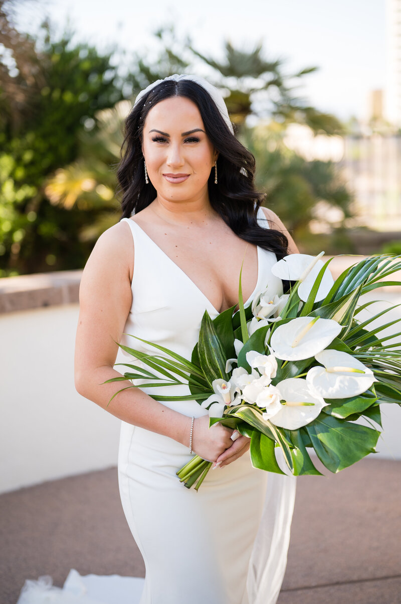 Bride posing in ‘The Archie’ gown from Love and Lace Bridal Salon at Emerald at Queensridge with soft natural light highlighting her modern bridal look.