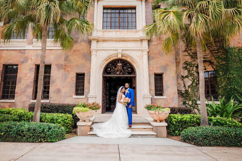 bride and groom posed outside of Orlando wedding venue