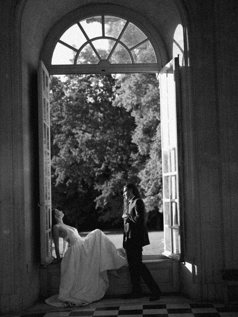 bride and groom in french chateau window