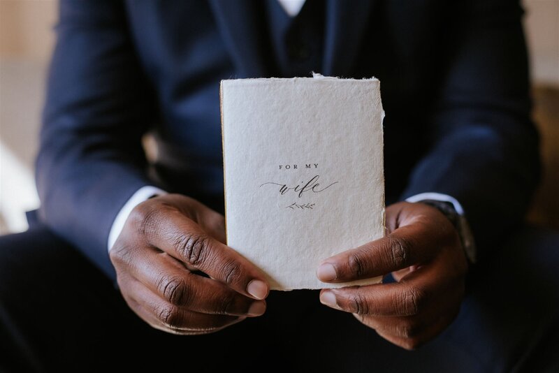 Groom holding his vow book