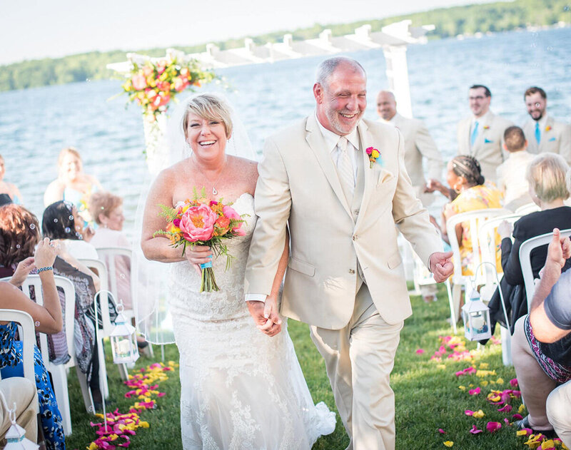 bride and groom walking down the aisle after wedding