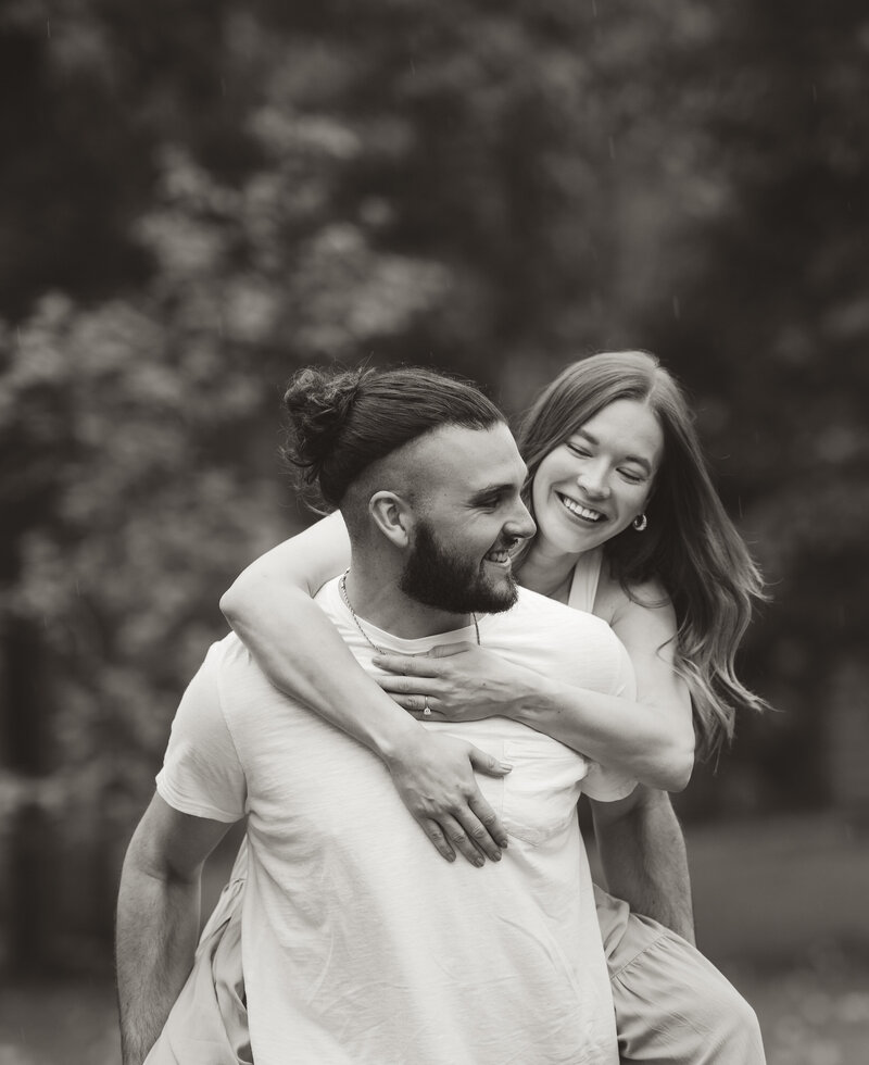 groom piggy backing bride for an engagement photo at Wisconsin national park