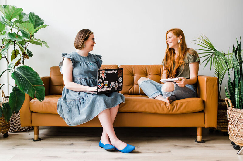 Copywriter Sara Gillis talking to another woman on a couch