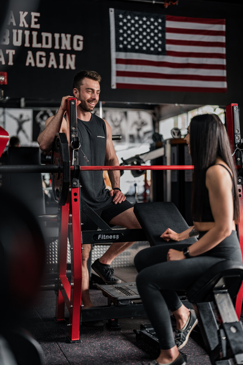 2 personal trainers chatting and smiling at each other