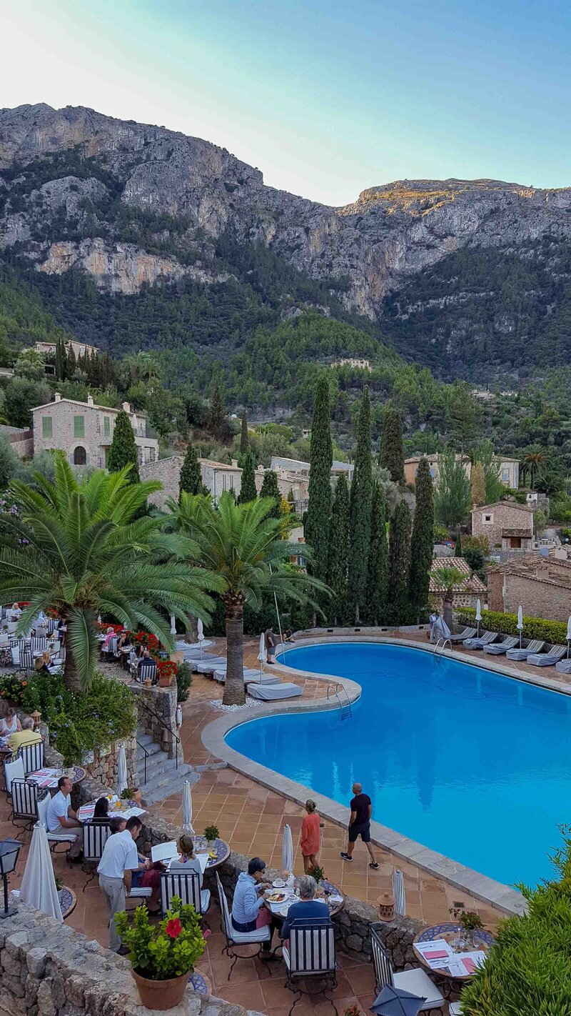 Dining terrace overlooking a pool and the Tramuntana Mountains at Belmond La Residencia in Mallorca ©Stephanie Dosch | theViatrix Spain Private Luxury Travel