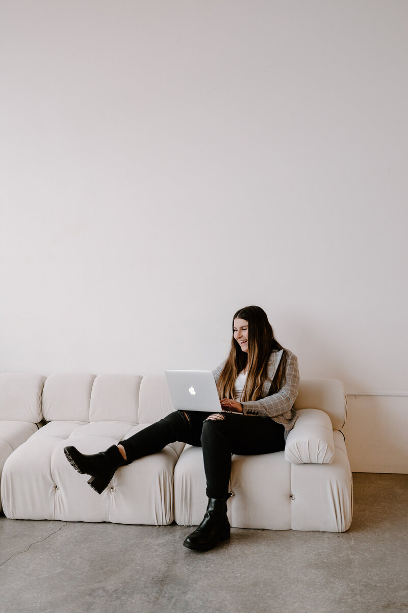 woman with laptop on couch