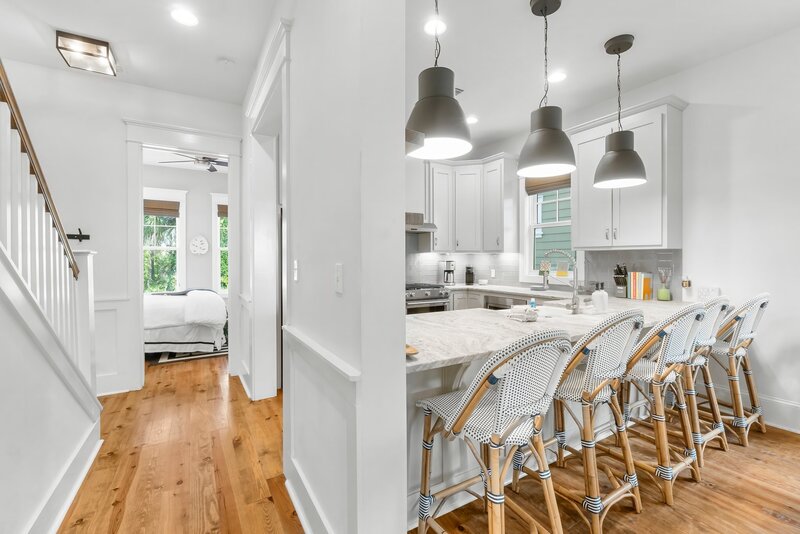 Stainless steel gas range, microwave, and modern cabinetry in the fully stocked kitchen of this Carillon Beach rental.
