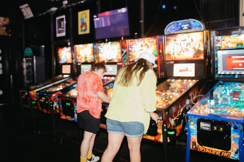 two people playing an arcade game