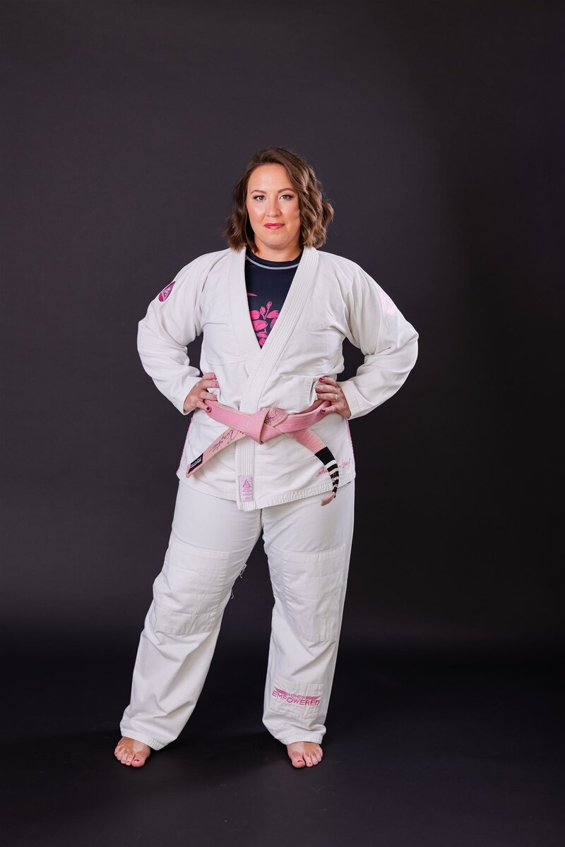 Evolve Therapy & Consulting owner wearing her gi and pink belt