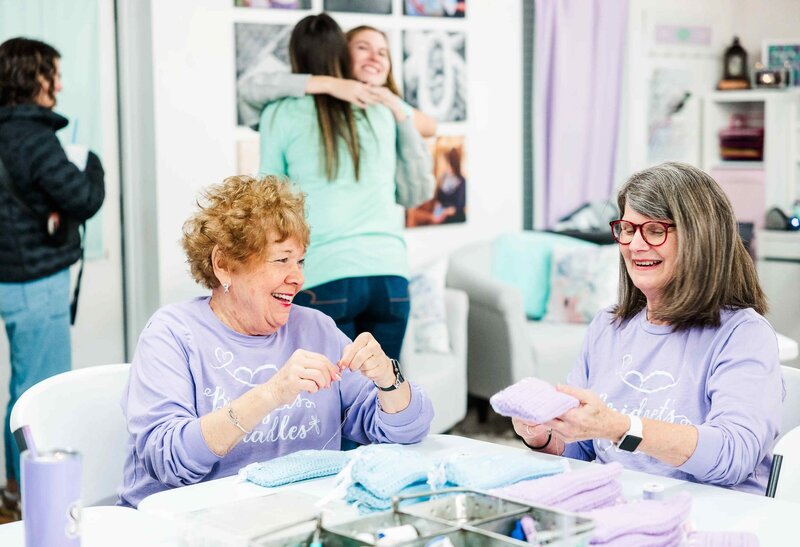 volunteers sewing cradles