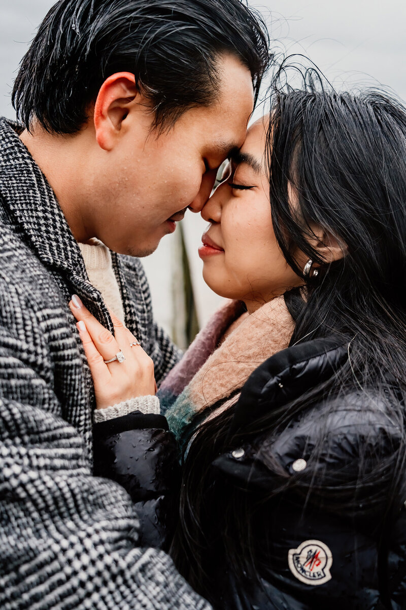 a photo of a couple close up, snuggled under a blanket. Very hallmark