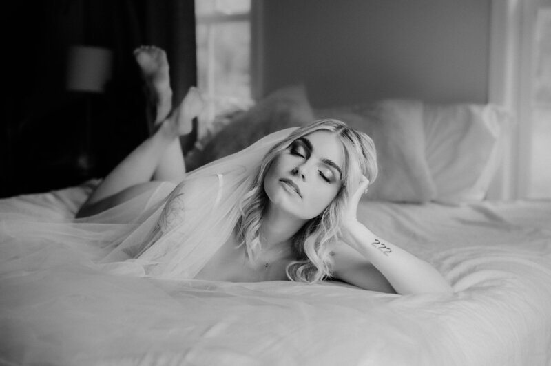 bride in wedding veil doing boudoir shoot with mayberry and stone for her wedding day gift for husband