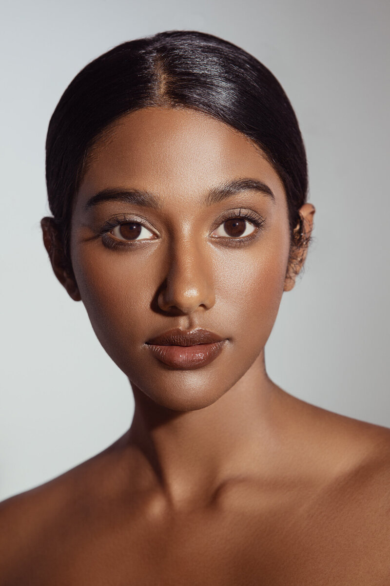 Sitara Masa in a soft-focus portrait, showcasing glowing skin and a natural smile, captured by Ylva Erevall.