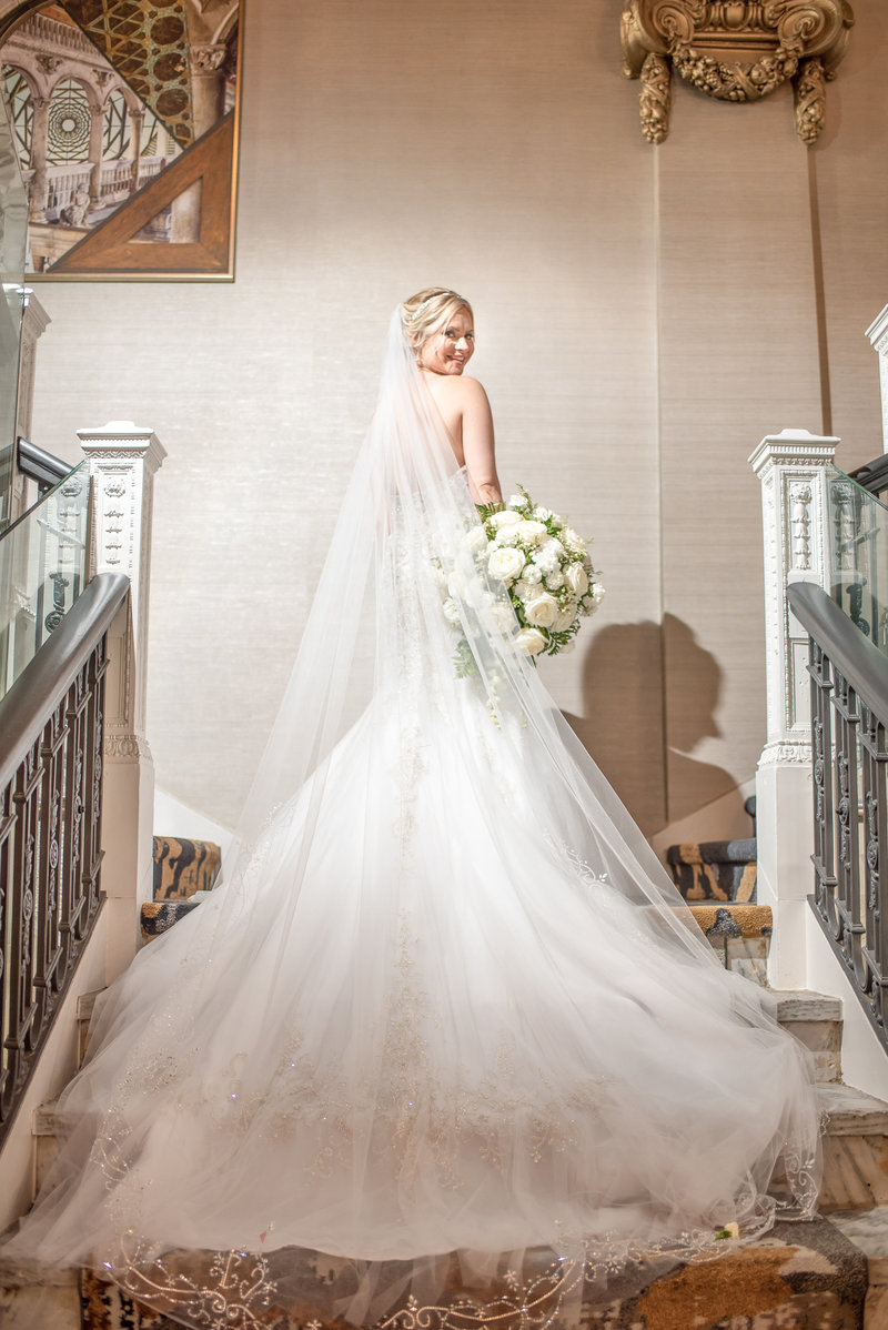 Back of bride's dress and veil on a stairway