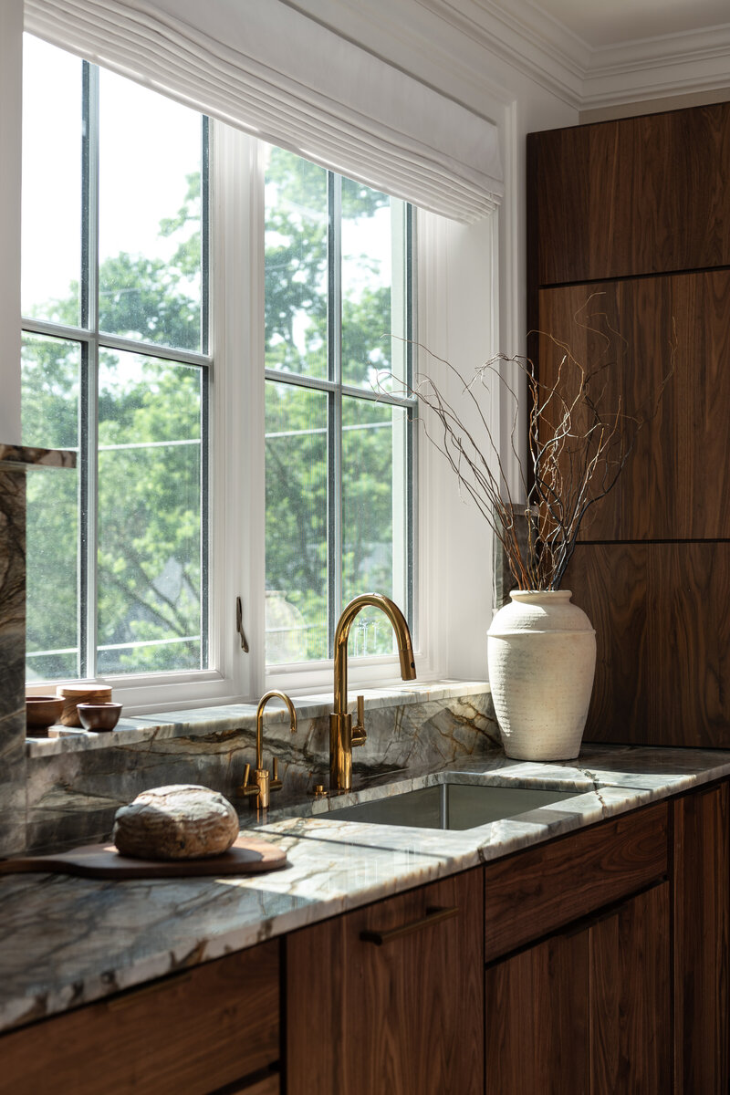 Dark wood moody kitchen with marble coutnertop
