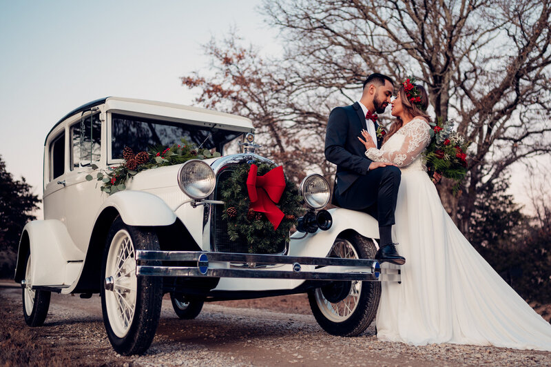 Bride and Grood kissing by an old car in Telluride