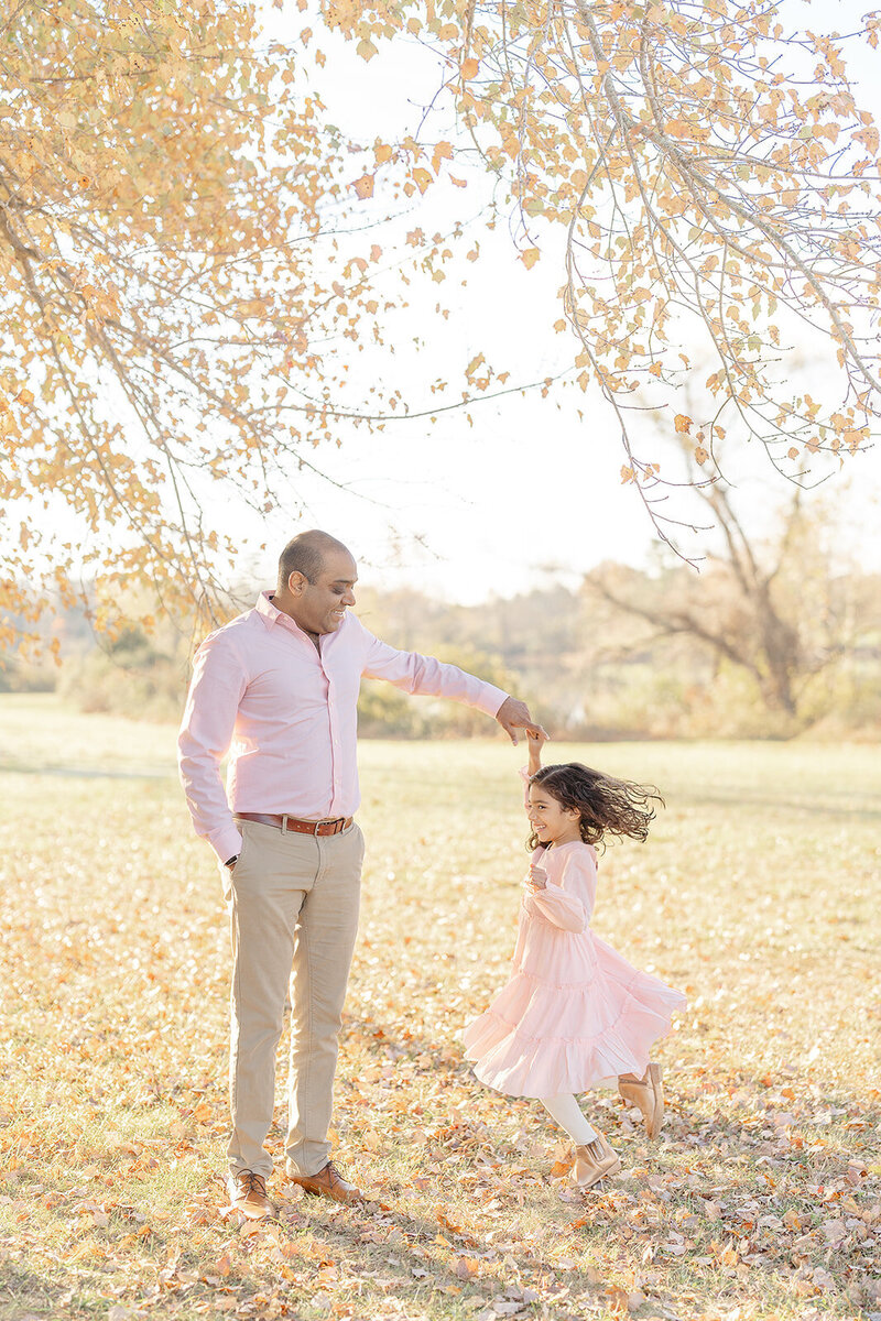 dad twirling his daughter during Fairfax County, VA family picture