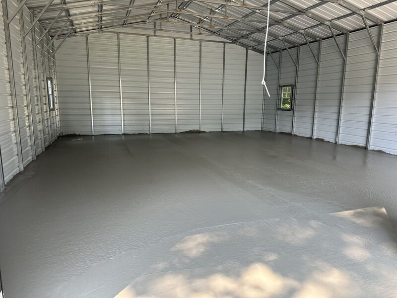 Freshly finished concrete shop floor inside a metal garage in Elkhart, IN