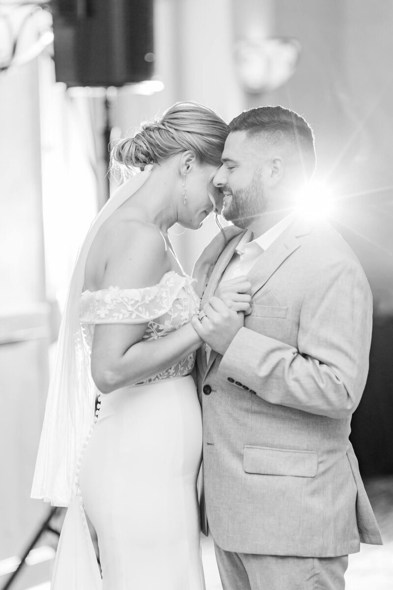 Black and white image of bride and groom first dance Bride and Groom dip kiss in front of Marriott Grand National | Opelika Alabama Wedding 