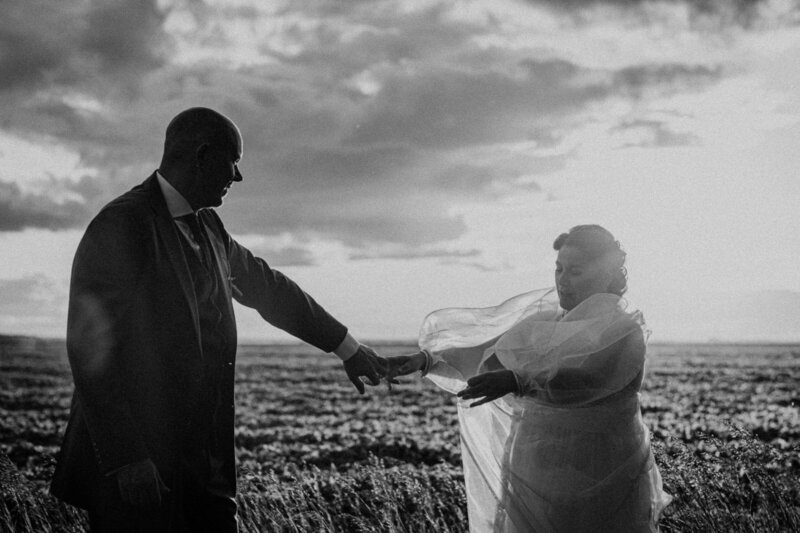 Bride and groom holding hands in the sunset 