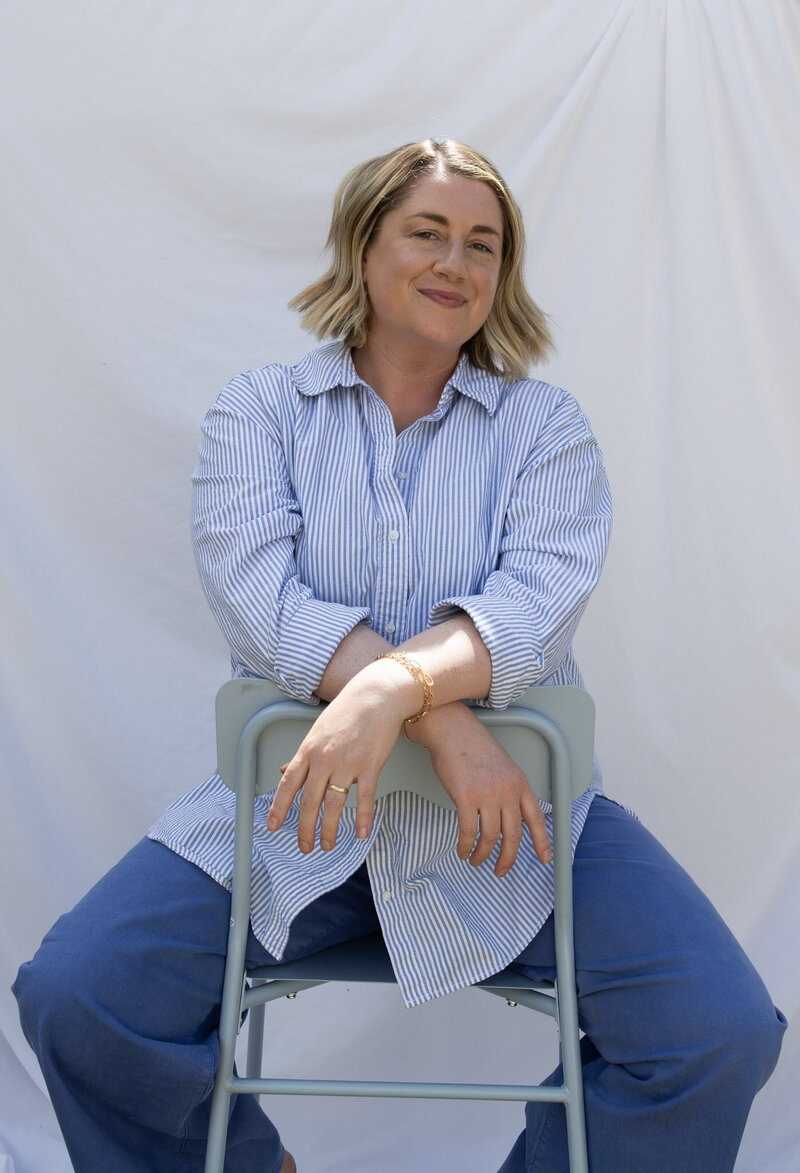 Graphic, web and branding designer Bess Brownlee smiles outside in Missoula, Montana.