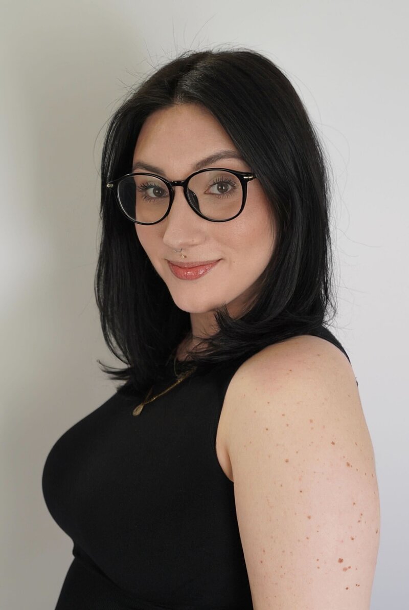 Salon Beau stylist with voluminous blonde waves, skilled in balayage and modern hairstyling.