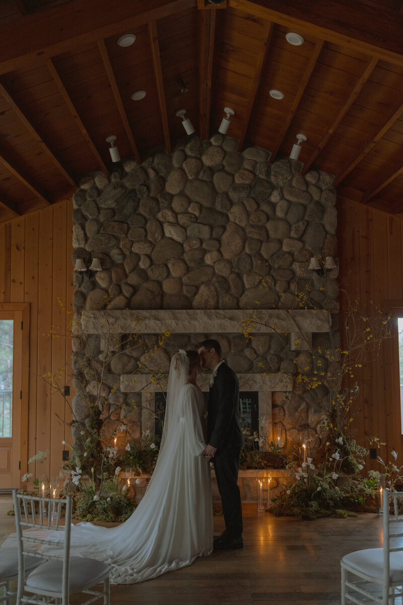 Man and woman walking away towards cabin in wedding attire