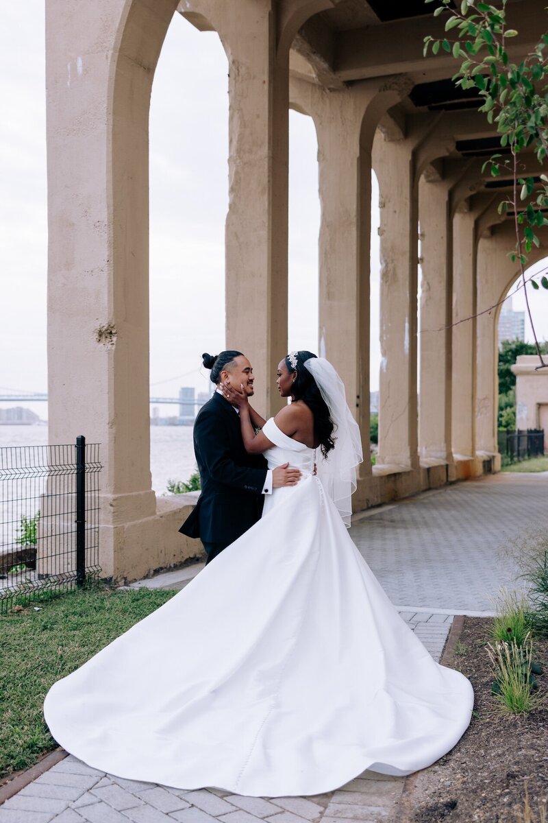 bride and groom embrace at venue for destination wedding