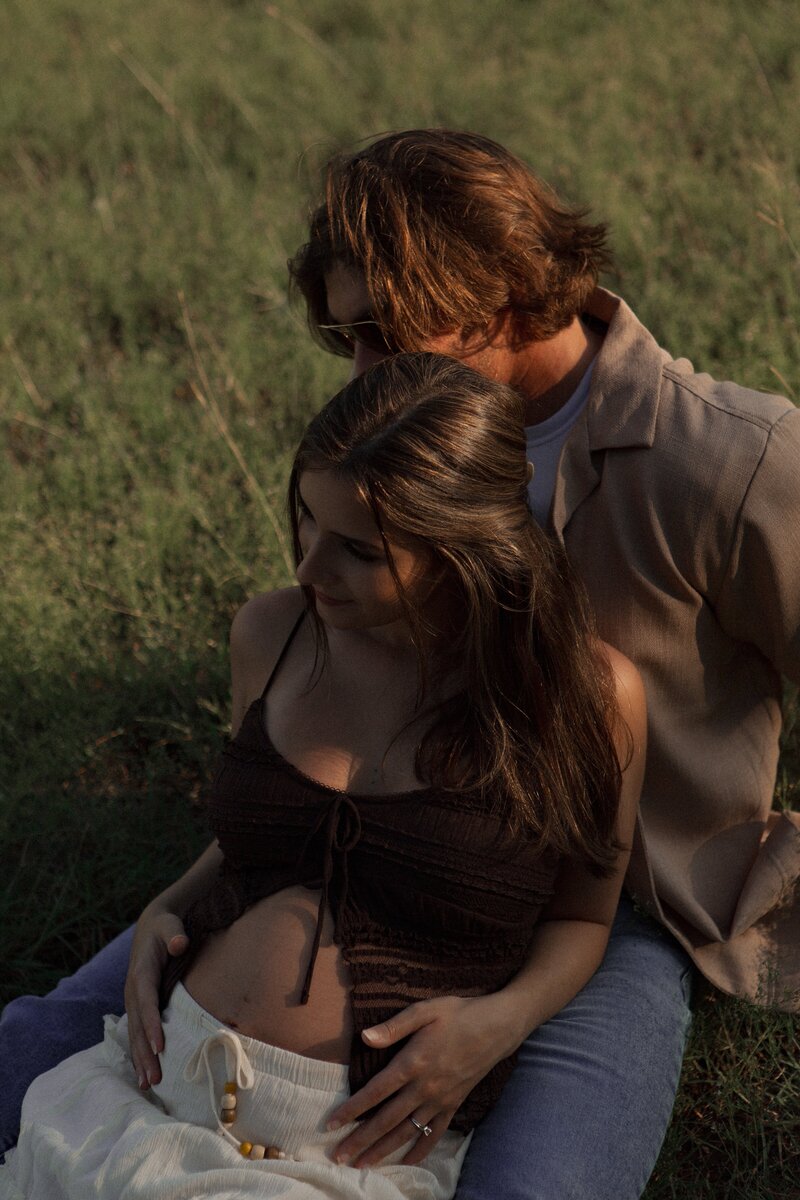 Romantic couples photography of a couple cuddling in the golden grass