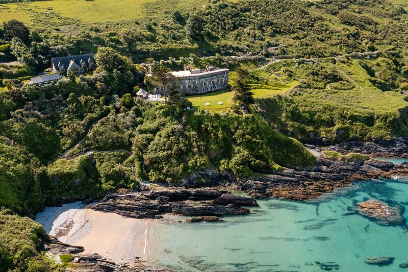 An aerial shot of Polhawn Fort from the distance