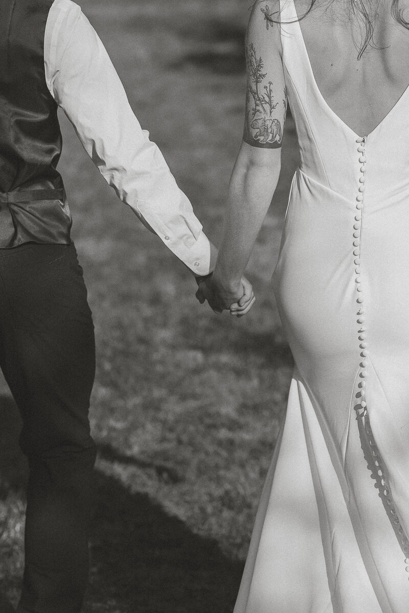 bride and groom holding hands during their wedding portraits in the Comox Valley by latitude 49 photography