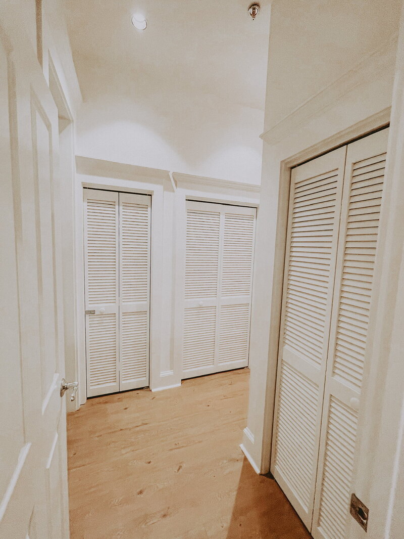 white hallway with many closets