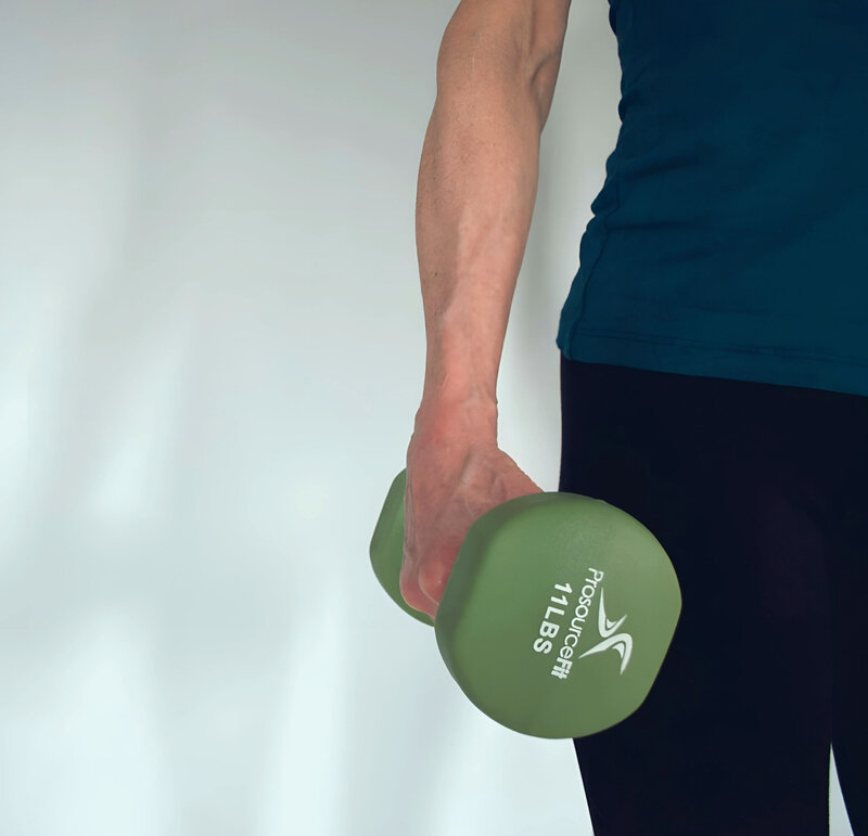 Light dumbbell hold demonstrating strength work for midlife bodies