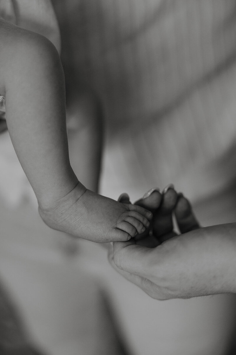 mom and son looking at baby goats for a family farm photo session